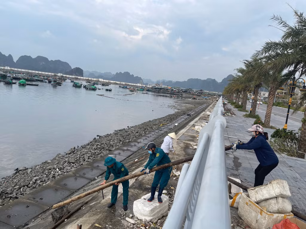 Các lực lượng của phường Cẩm Thủy thu gom rác thải ven bờ.