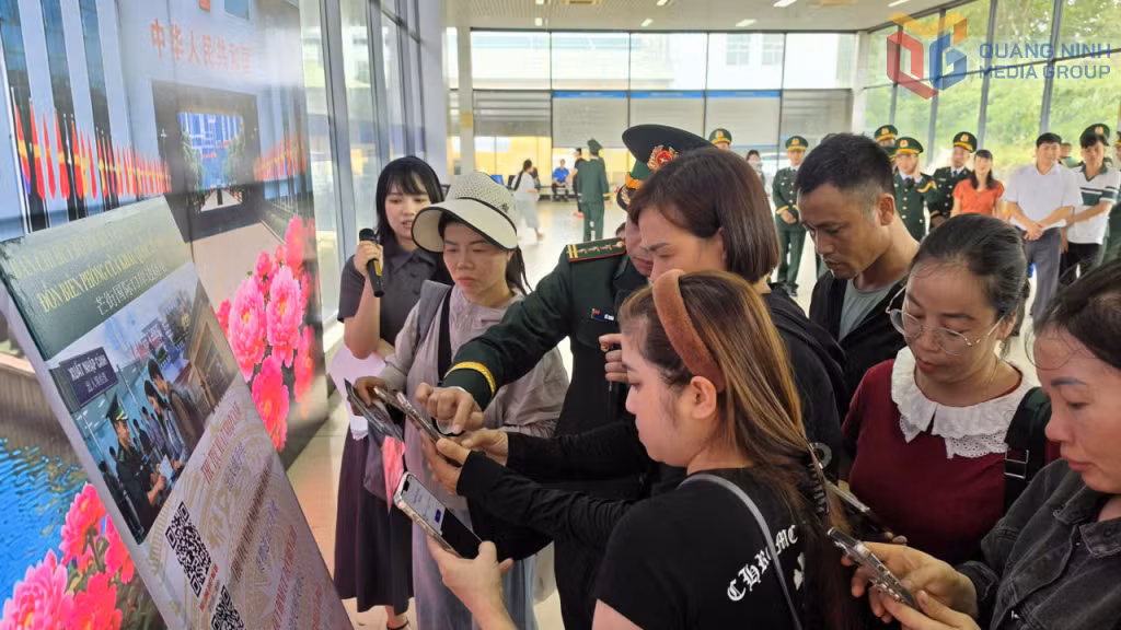  Cán bộ Đồn Biên phòng cửa khẩu quốc tế Móng Cái hướng dẫn người dân quét mã QR tìm hiểu các quy định của pháp luật về XNC.