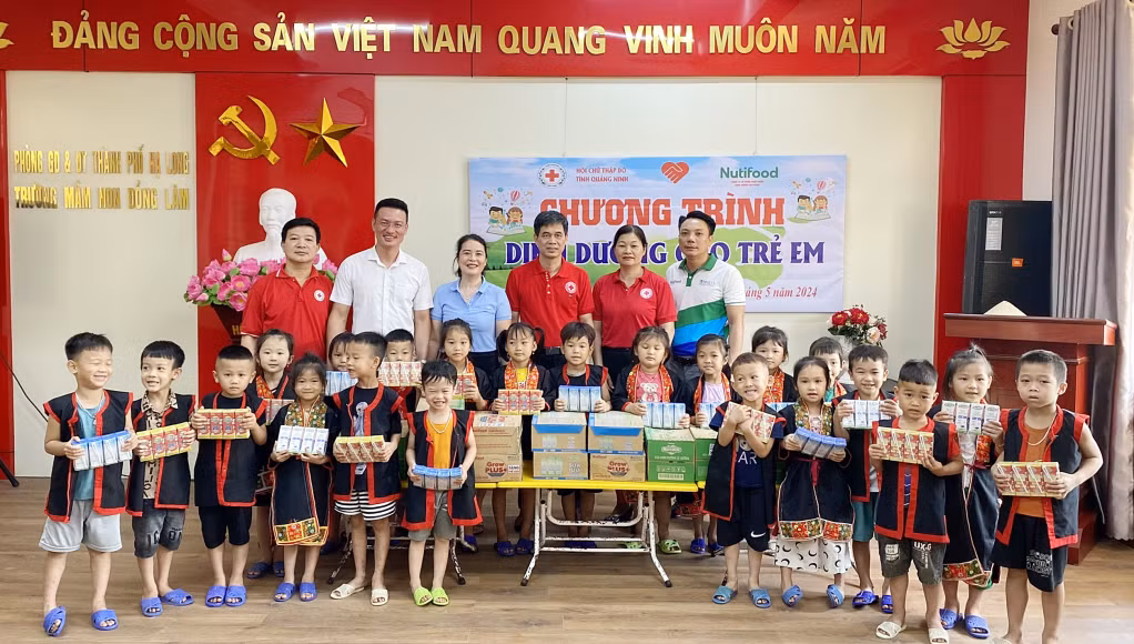 Lãnh đạo Hội CTĐ tỉnh và Công ty CP Thực phẩm dinh dưỡng NutiFood trao tặng sữa cho các em học sinh Trường Mầm non xã Đồng Lâm (TP Hạ Long). Ảnh: Dương Trường.