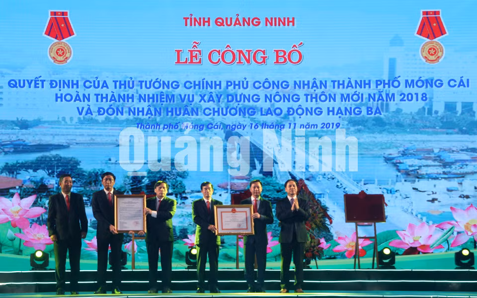 Phó Chủ tịch Thường trực UBND tỉnh Đặng Huy Hậu trao quyết định của Thủ tướng Chính phủ công nhận TP Móng Cái hoàn thành nhiệm vụ xây dựng NTM năm 2018 (11-2019). Ảnh Hữu Việt