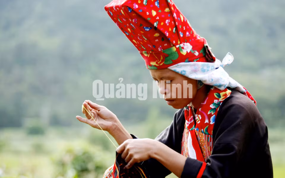 Phụ nữ Dao Thanh Phán Bình Liêu thường đội một chiếc mũ màu đỏ giống như một cái hộp trên đầu, rồi chùm lên một chiếc khăn cũng màu đỏ hoa văn sặc sỡ. Ảnh: Dương Phương Đại