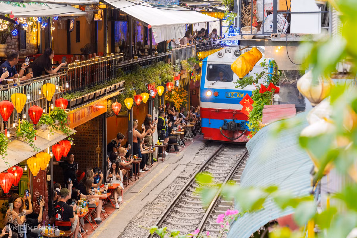 Phố cà phê đường tàu nằm giáp ranh 3 phường Điện Biên (quận Ba Đình), Cửa Nam, Hàng Bông (quận Hoàn Kiếm), dù đã có lệnh cấm từ năm 2019, con phố có thời điểm thưa khách nay đông đúc trở lại. Hôm 24/11, hàng trăm, có thời điểm hàng nghìn du khách đổ về các quán cà phê trong phố check in mỗi khi có chuyến tàu đi qua.