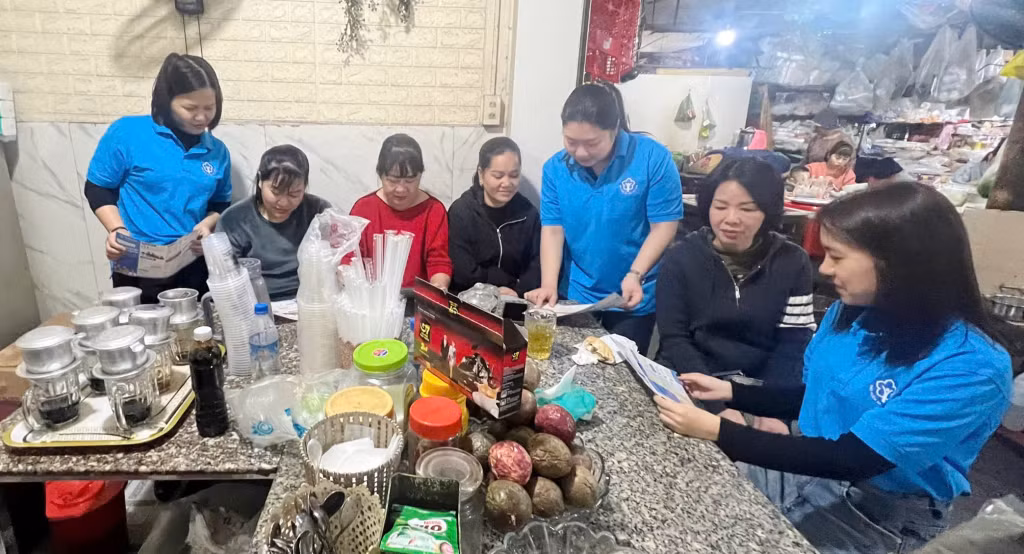 Cán bộ BHXH TP Cẩm Phả vận động hộ tiểu thương tham gia BHXH tự nguyện.