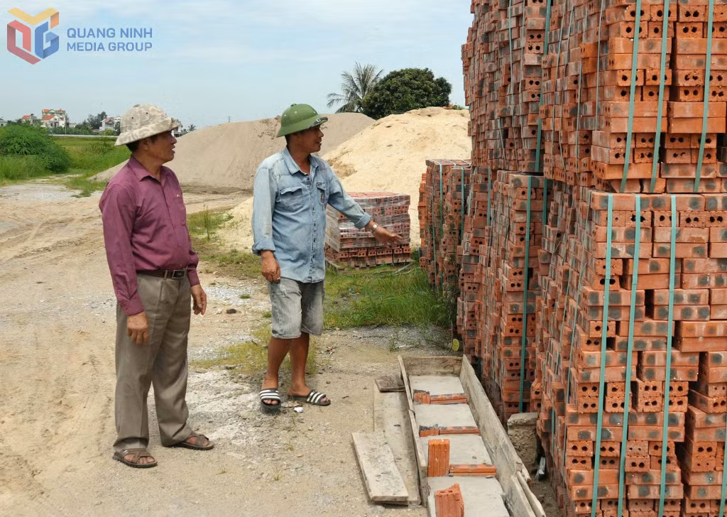 CCB Bùi Huy Minh (bên trái), Giám đốc Công ty TNHH MTV Minh Làn, trao đổi với công nhân về chất lượng vật liệu phục vụ thi công.