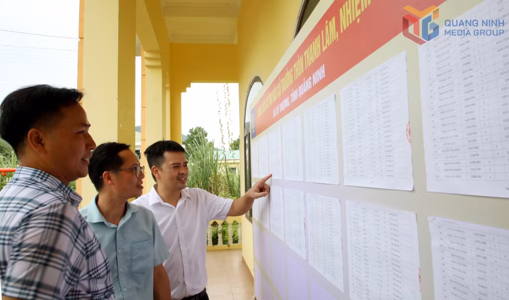 Cán bộ xã và thôn Thanh Lâm rà soát danh sách cử tri niêm yết tại nhà văn hóa thôn.