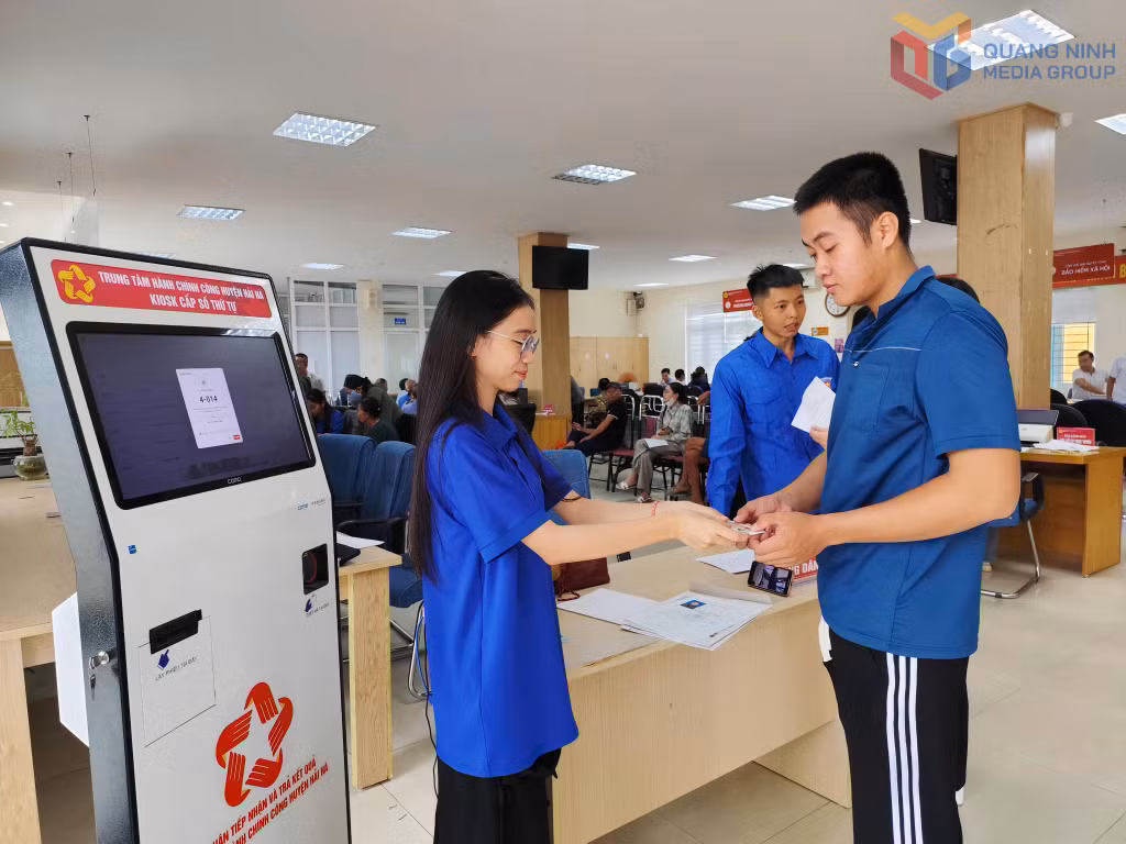 ĐVTN xã Quảng Đức hướng dẫn người dân lấy số làm TTHC tại Trung tâm HCC xã Quảng Đức.