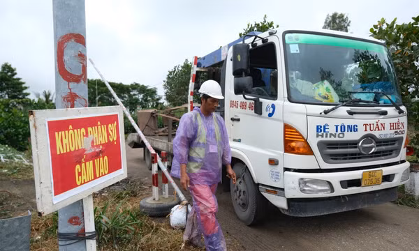 Mưa lớn gây cản trở việc kéo ống cọc bê tông có bé trai 10 tuổi lên