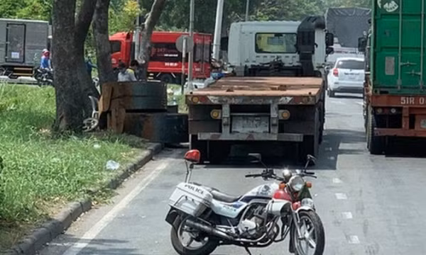 Cuộn thép trên xe đầu kéo rơi xuống đường, đụng trúng người bán vé số
