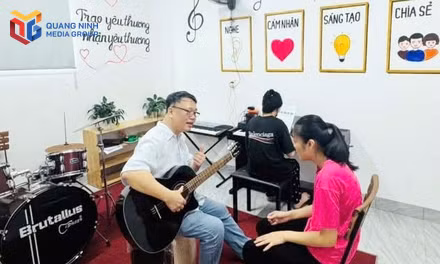 Em Trần Thị Oanh được nhạc sĩ Nguyễn Thiện Minh hướng dẫn cảm thụ âm nhạc trong buổi học đầu tiên của lớp âm nhạc dành cho trẻ rối loạn phát triển tại Trung tâm Hỗ trợ phát triển giáo dục hòa nhập Hướng Dương.