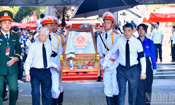Nguyên Chủ tịch nước Nguyễn Minh Triết và Thủ tướng Chính phủ Lê Minh Hưng cùng thực hiện nghi thức đưa hài cốt các Anh hùng liệt sĩ từ Công viên Lê Thị Riêng về Nghĩa trang Liệt sĩ Thành phố Hồ Chí Minh. (Ảnh: THANH GIANG)